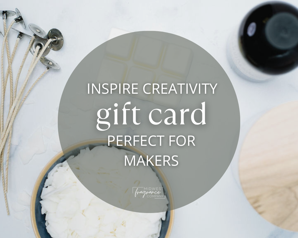 gift cards from midwest fragrance company with a background of candle wicks, fragrance oils, and waxes