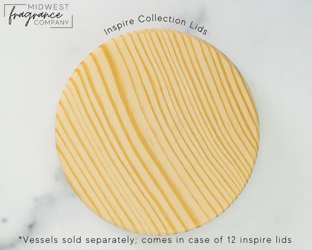 The top of a single natural pine wood lid for Inspire candle vessels on a white background, showing the wood variations.