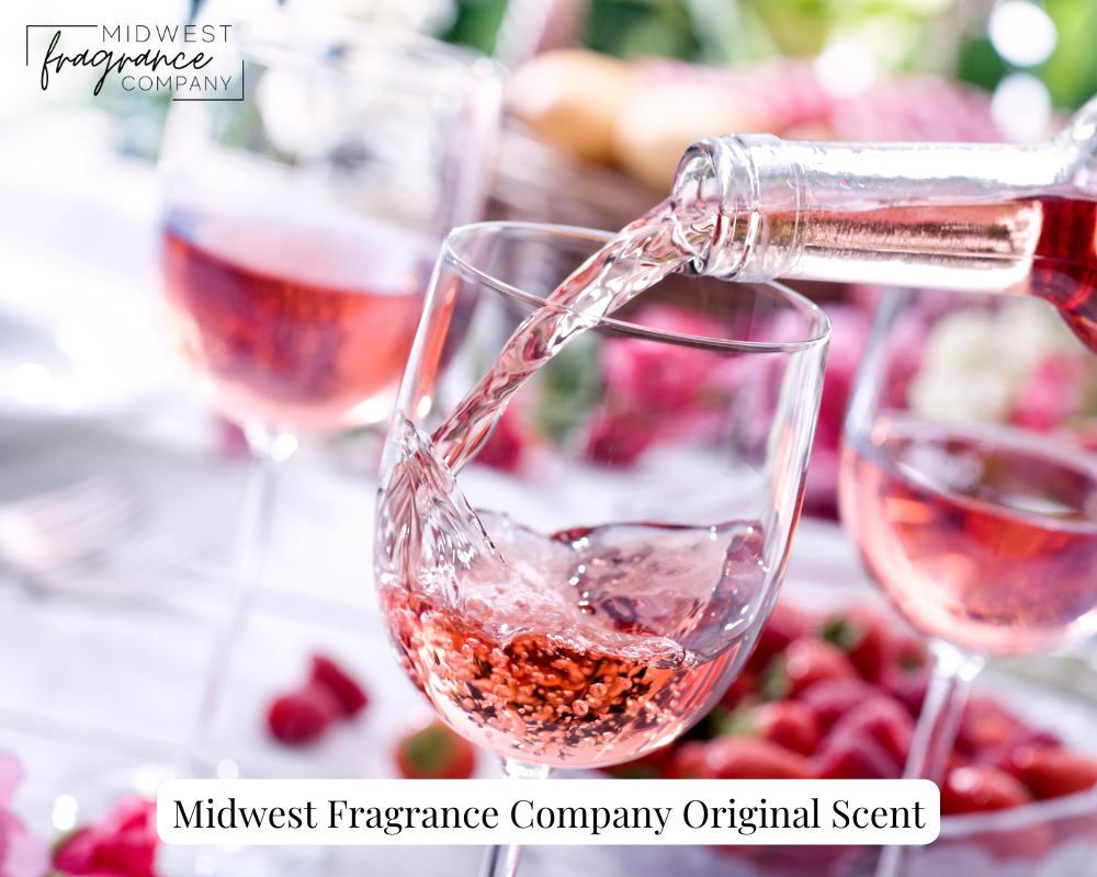 A sparkling red raspberry beverage being poured into a clear wine glass depicting a fruity and floral fragrance called Loveberry Crush.