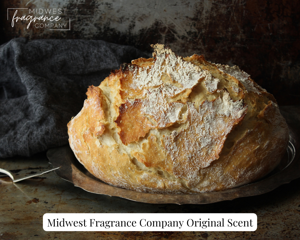 Rustic loaf of freshly baked artisan bread with napkin and butter knife.